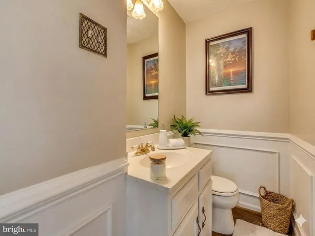a bathroom with a sink a toilet and shower curtain