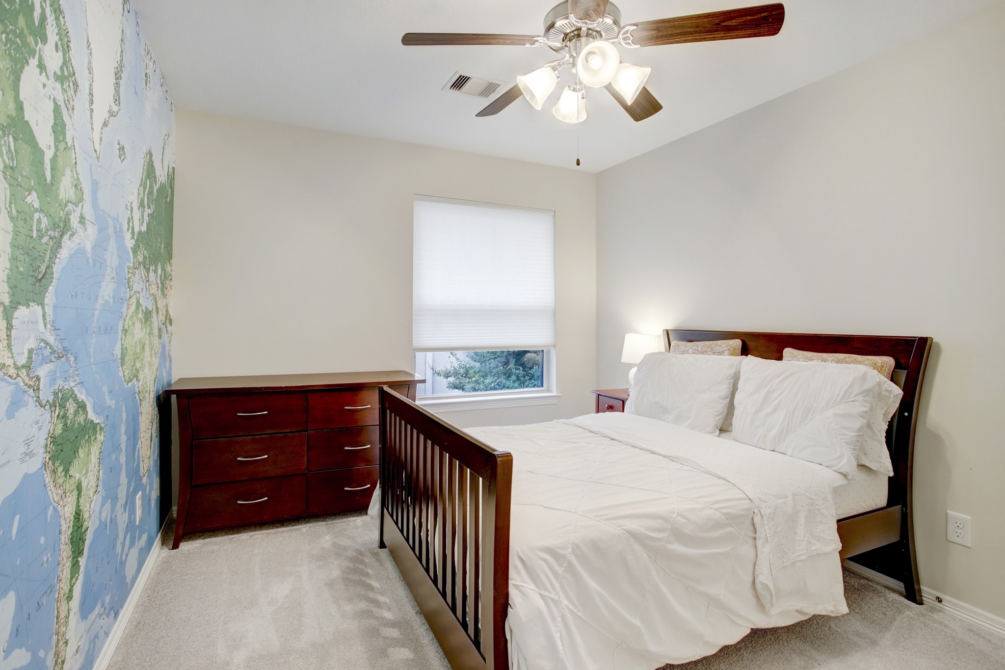4230 Drake Street Houston, TX 77005 - Photo 22 of 38 Bedroom 2 – This room has a sizeable walk-in closet, a window with shades, a plush carpet and a ceiling fan/light fixture. The centerpiece is the beautiful world map mural.