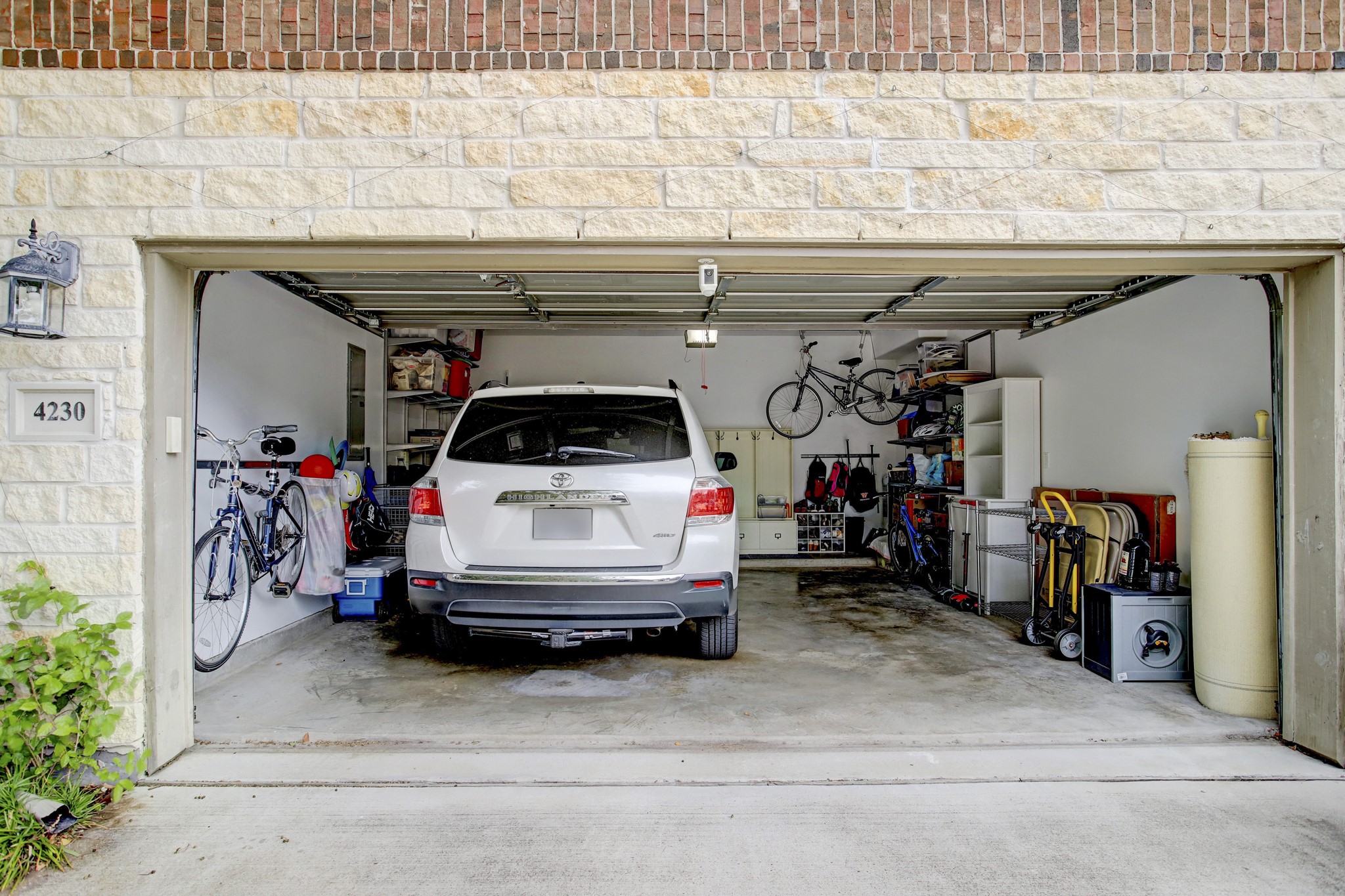 4230 Drake Street Houston, TX 77005 - Photo 26 of 38 Garage - You will have ample parking capacity with the spacious 2-car garage and double-wide, private driveway, which can accommodate two additional vehicles. The white shelves on the right provide extra storage and the shelves with hooks straight ahead serve as a mud room. Both are included in the lease.