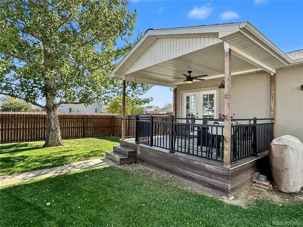 a view of a backyard with a small cabin and wooden fence