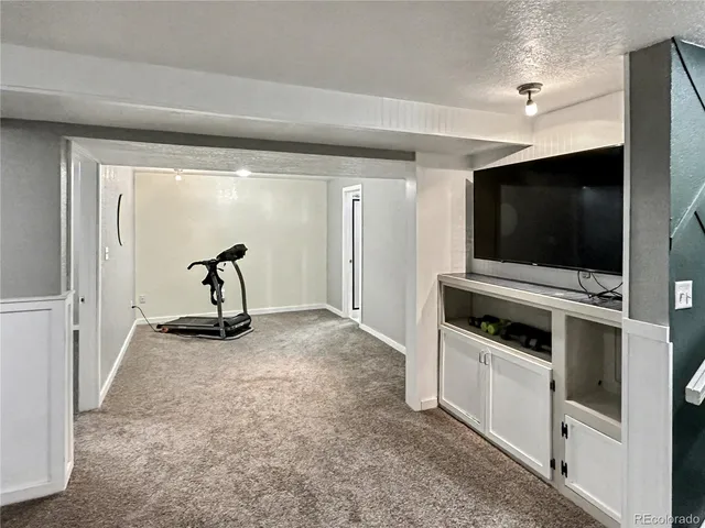 a view of a livingroom with furniture and a flat screen tv