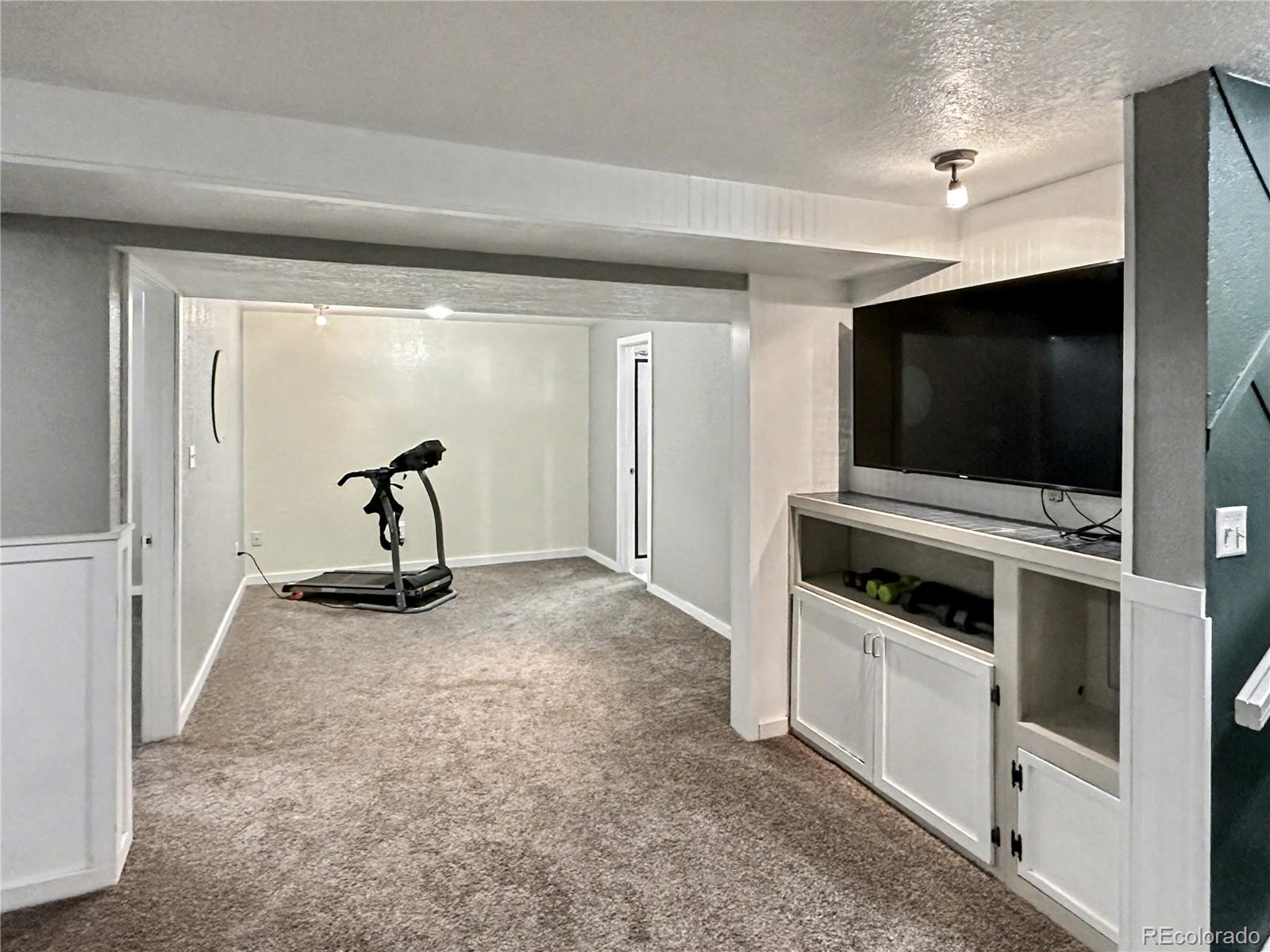 804 Nicole Road Sterling, CO 80751 - Photo 17 of 24 a view of a livingroom with furniture and a flat screen tv