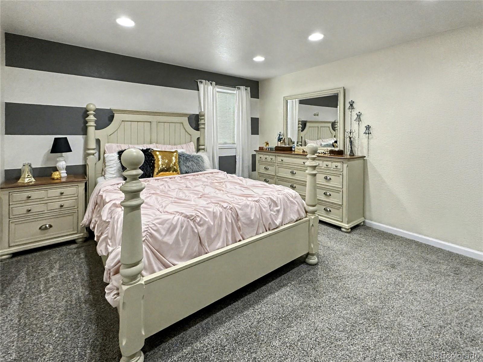 804 Nicole Road Sterling, CO 80751 - Photo 19 of 24 a bedroom with a bed and a cabinets
