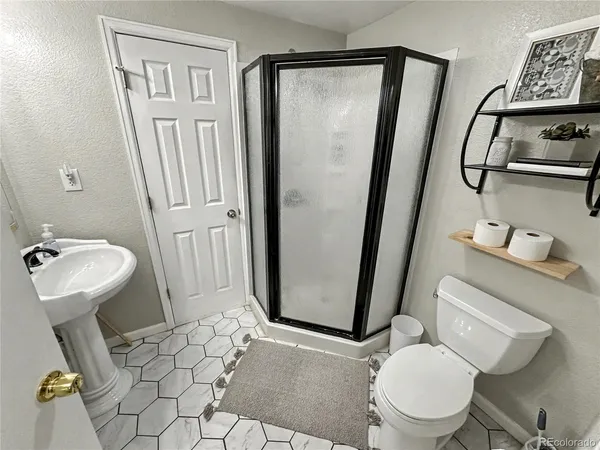 a white toilet sitting next to a bathroom sink