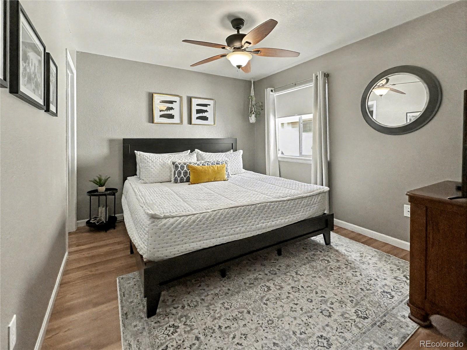 804 Nicole Road Sterling, CO 80751 - Photo 6 of 24 a bedroom with a bed and a chandelier