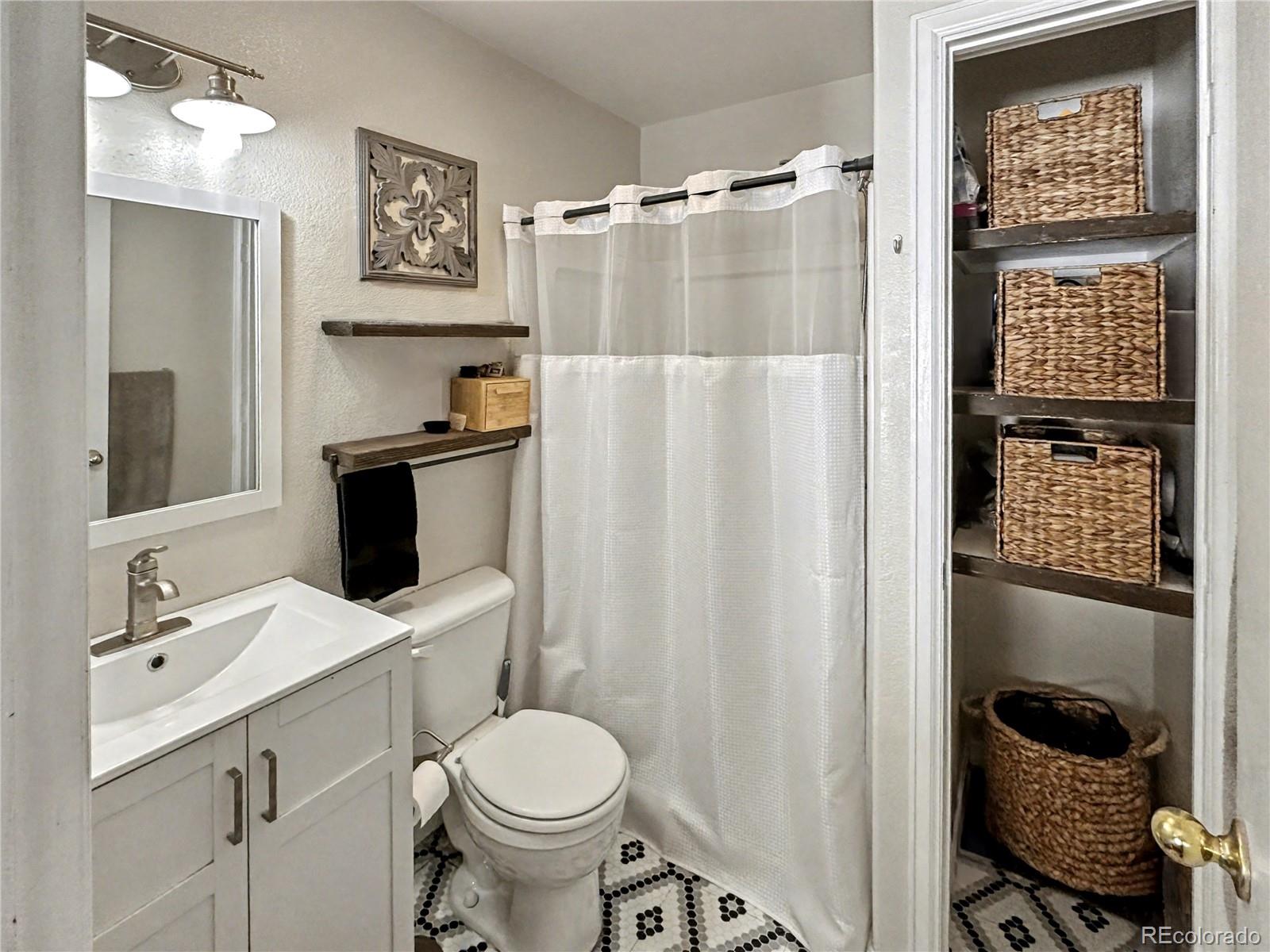 804 Nicole Road Sterling, CO 80751 - Photo 7 of 24 a bathroom with a sink toilet and shower