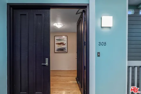 a view of a hallway with a wooden door