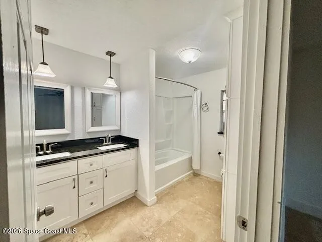 an empty room with a ceiling fan and window