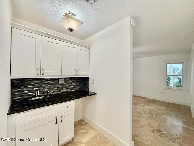 a bathroom with a granite countertop sink a toilet and a mirror