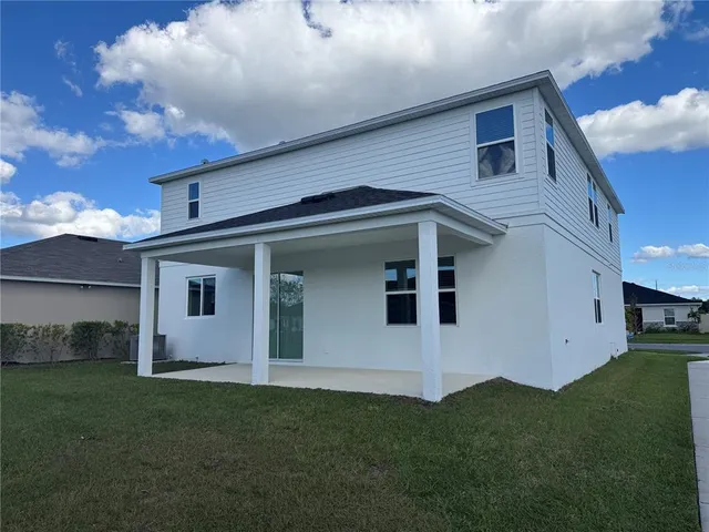 a view of a refrigerator in kitchen and white cabinets