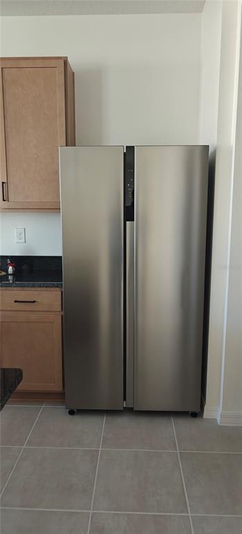 3820 Elk Blf Road St. Cloud, FL 34772 - Photo 22 of 23 a view of a refrigerator in kitchen and white cabinets