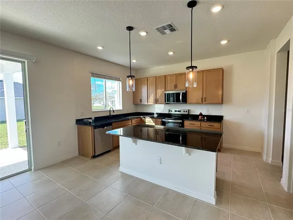 a kitchen with a sink a counter top space and appliances