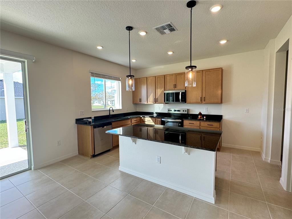 3820 Elk Blf Road St. Cloud, FL 34772 - Photo 8 of 23 a kitchen with a sink a counter top space and appliances