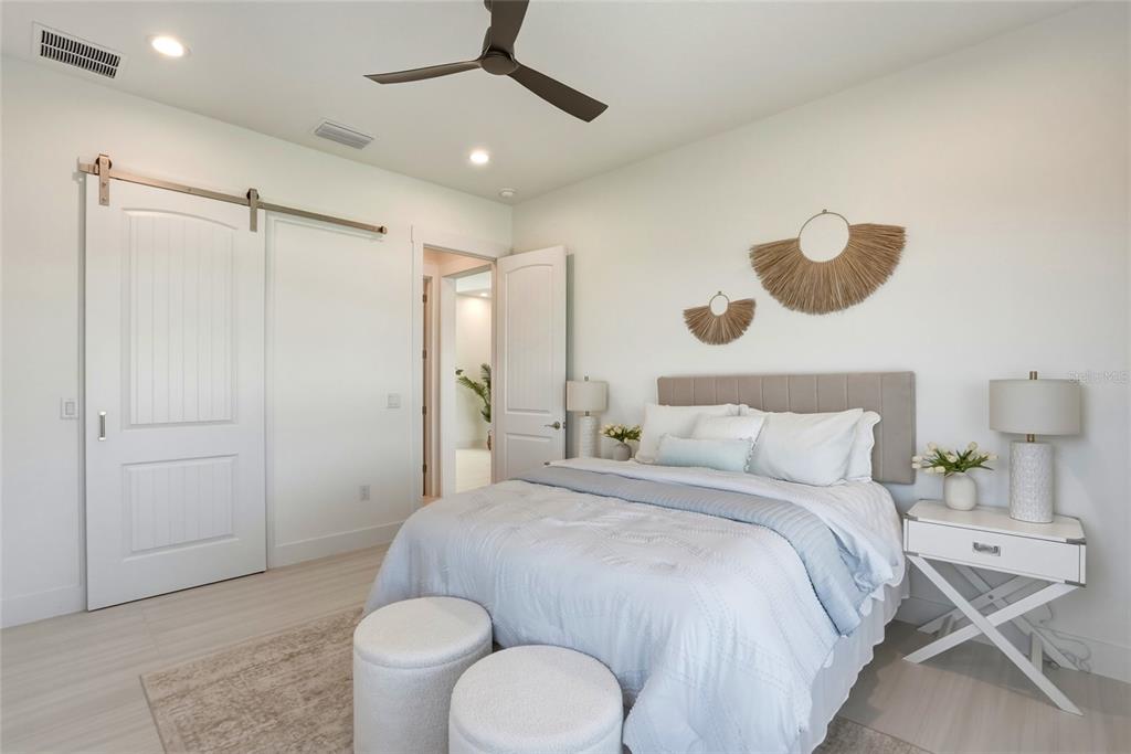 534 Crystal Drive Madeira Beach, FL 33708 - Photo 38 of 68 a bedroom with a bed and bathroom