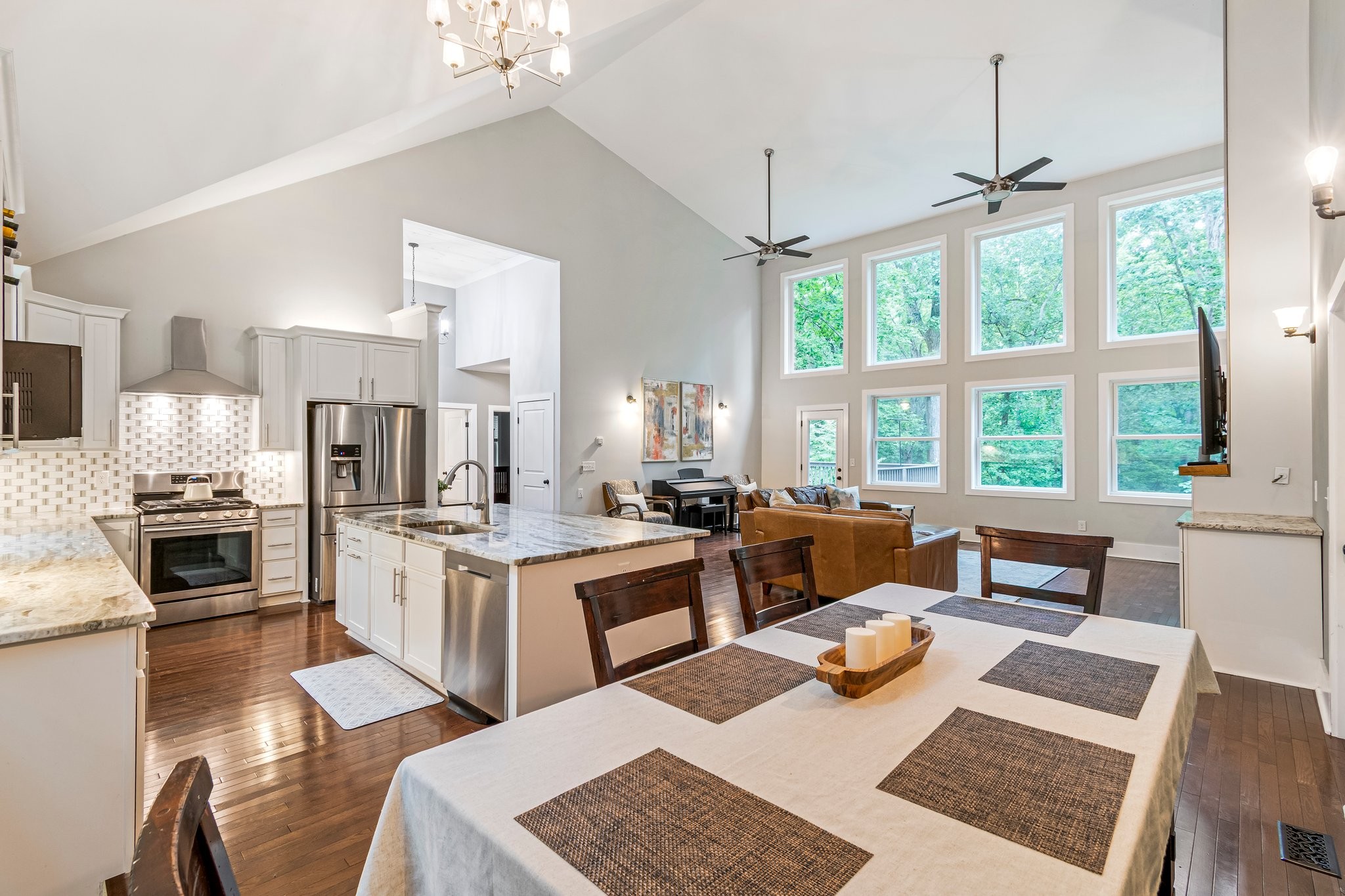 4545 Sears Road Pegram, TN 37143 - Photo 23 of 68 a kitchen with a stove a sink dishwasher a dining table and chairs with wooden floor
