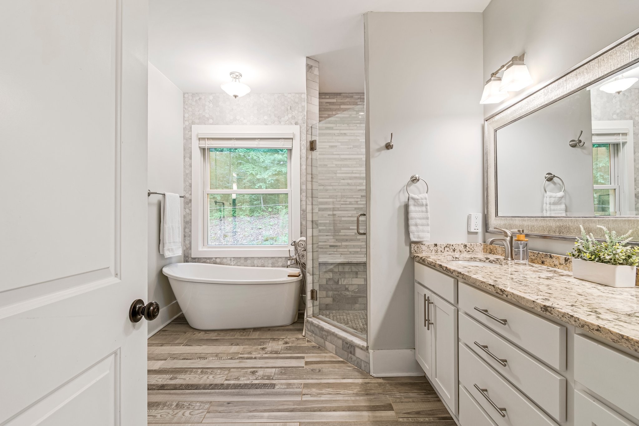 4545 Sears Road Pegram, TN 37143 - Photo 30 of 68 a bathroom with a granite countertop sink mirror vanity bathtub and next to a window