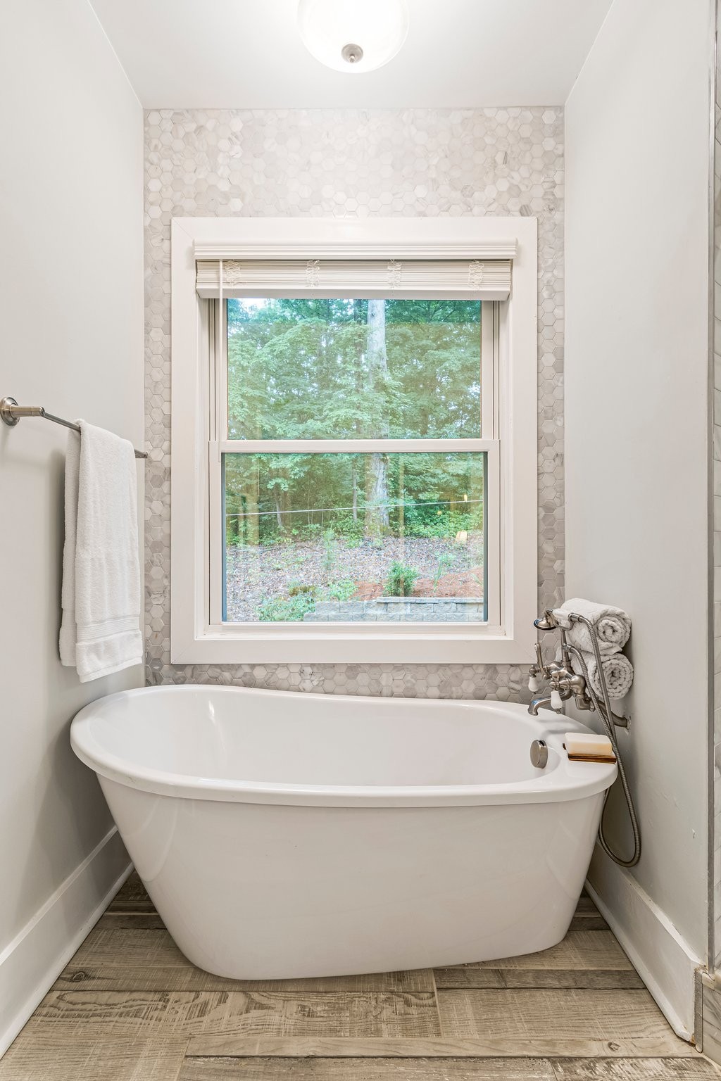 4545 Sears Road Pegram, TN 37143 - Photo 32 of 68 a white bath tub sitting in a bathroom next to a window