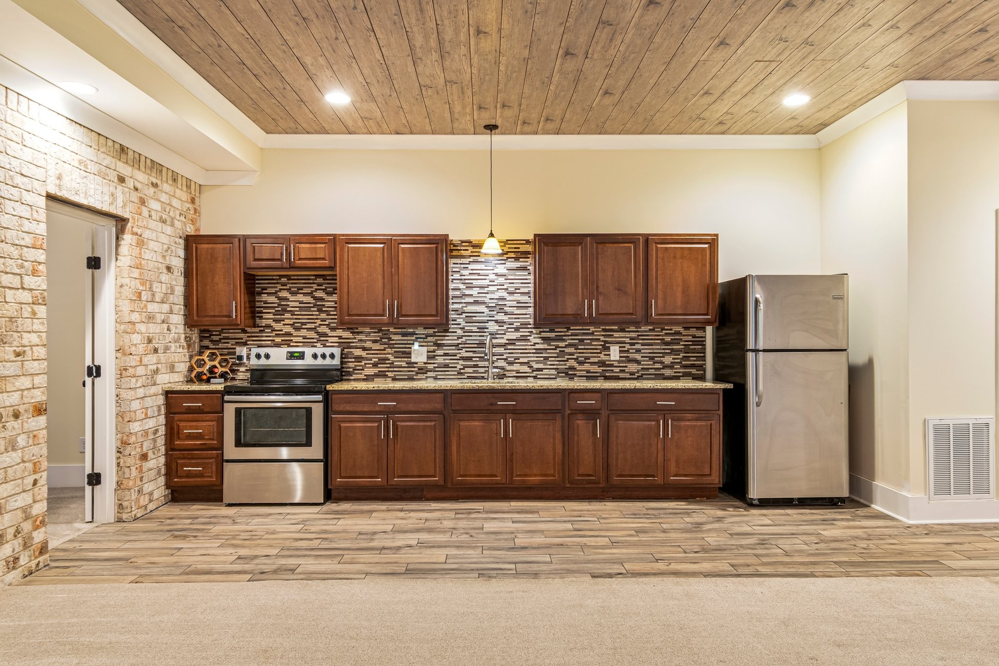 4545 Sears Road Pegram, TN 37143 - Photo 43 of 68 a kitchen with stainless steel appliances granite countertop a stove a sink and a refrigerator