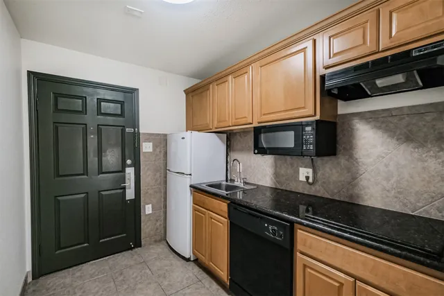 a kitchen with stainless steel appliances a refrigerator and a stove top oven