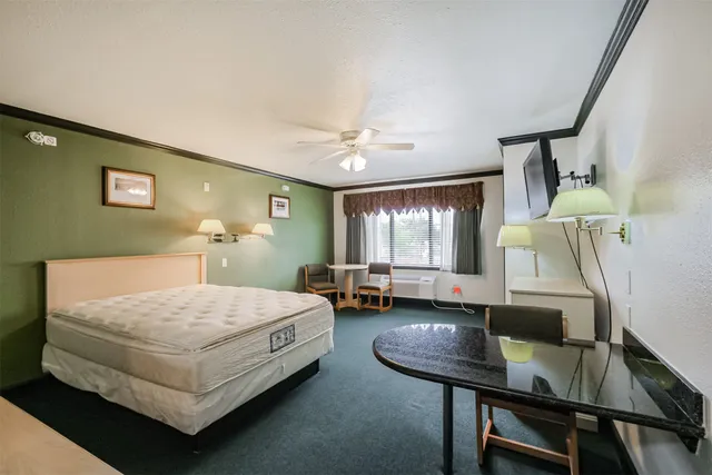 a bedroom with a bed and a table