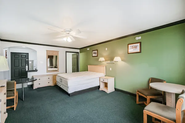 a bed room with a bed and a chair