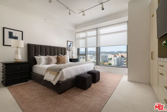 a bed room with a bed and a large window