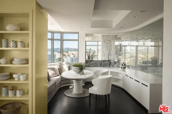 a room with patio furniture and a floor to ceiling window