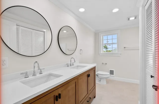 a bathroom with a double vanity sink and a mirror
