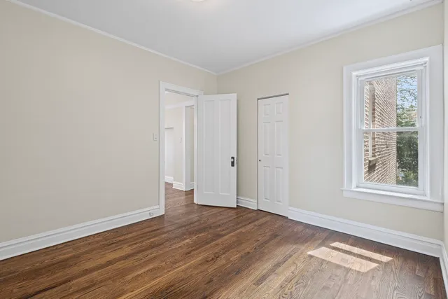 a view of a livingroom with wooden floor and window