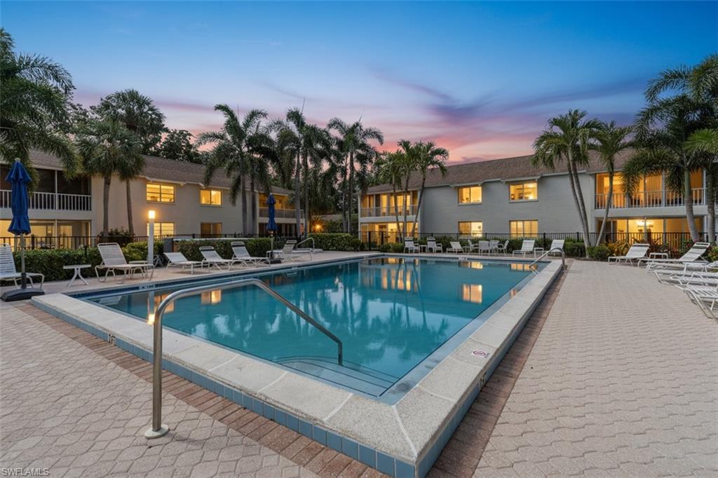 a view of swimming pool with outdoor seating and a pathway