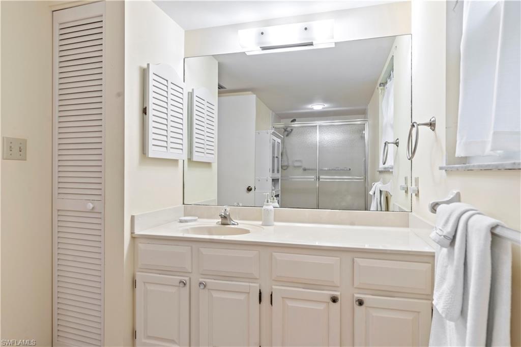 3200 Binnacle Drive, Unit C1 Naples, FL 34103 - Photo 11 of 37 a bathroom with a sink and a mirror
