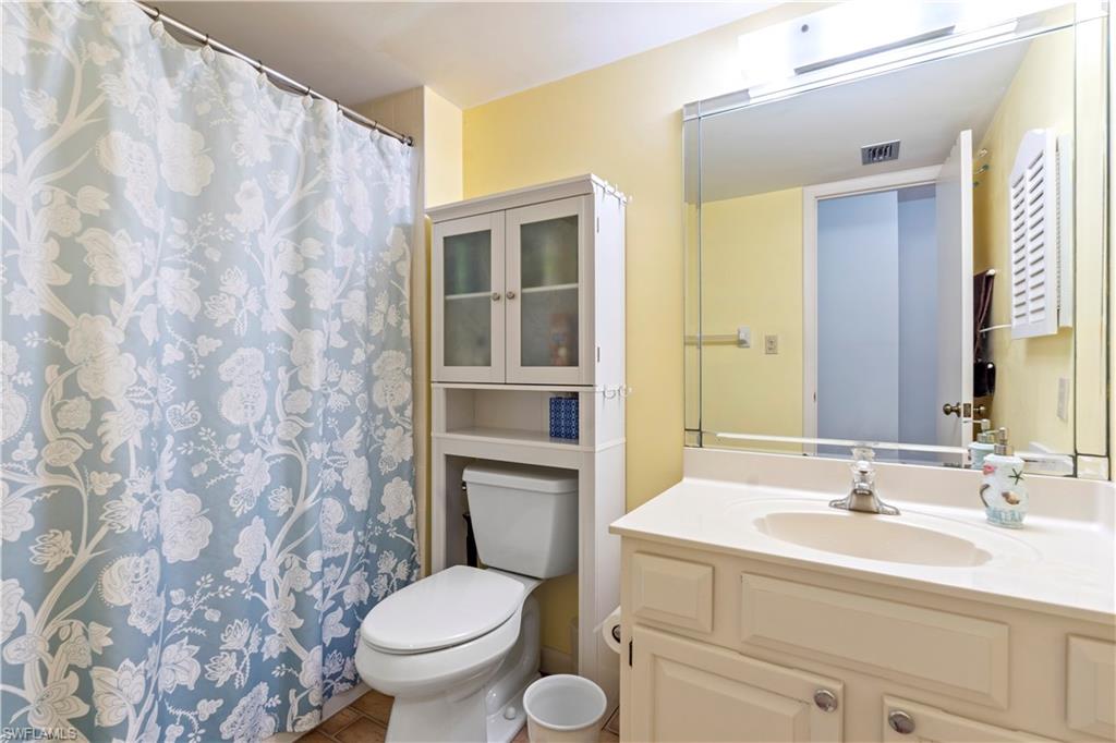 3200 Binnacle Drive, Unit C1 Naples, FL 34103 - Photo 15 of 37 a bathroom with a granite countertop sink a toilet and a mirror