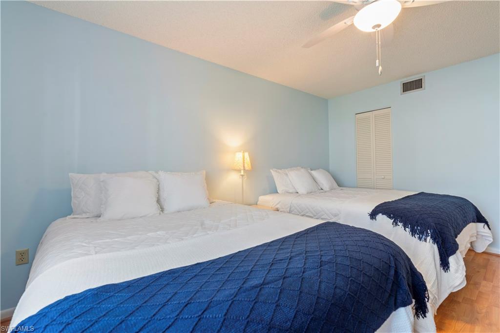 3200 Binnacle Drive, Unit C1 Naples, FL 34103 - Photo 17 of 37 a bedroom with a bed and a night stand