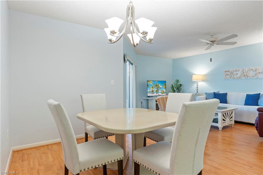 3200 Binnacle Drive, Unit C1 Naples, FL 34103 - Photo 18 of 37 a view of a dining room with furniture and wooden floor