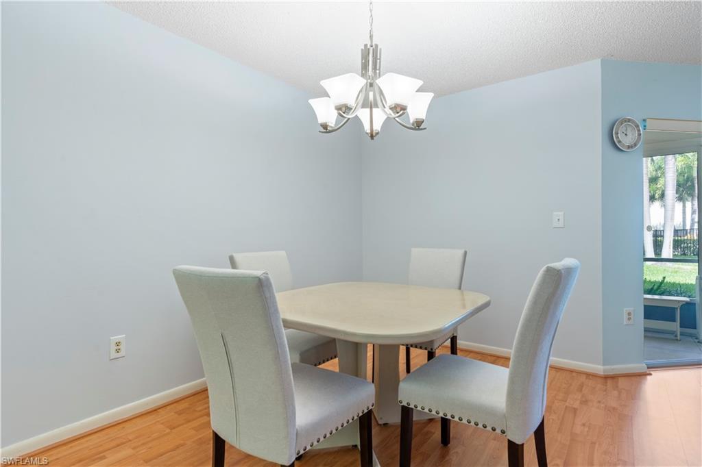 3200 Binnacle Drive, Unit C1 Naples, FL 34103 - Photo 19 of 37 a view of a dining room with furniture and wooden floor