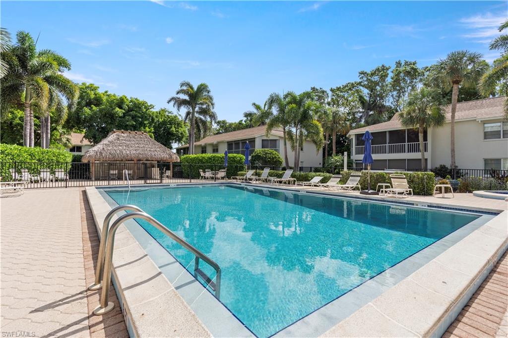 3200 Binnacle Drive, Unit C1 Naples, FL 34103 - Photo 25 of 37 a view of swimming pool with outdoor seating and yard