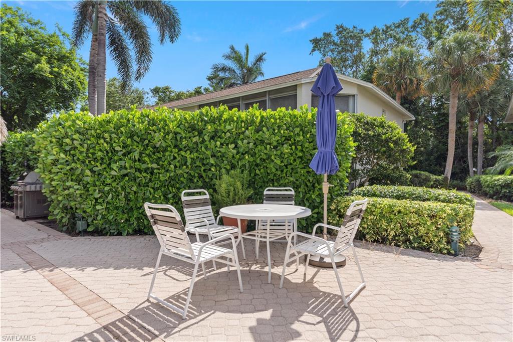 3200 Binnacle Drive, Unit C1 Naples, FL 34103 - Photo 26 of 37 a view of a chairs and table in the patio