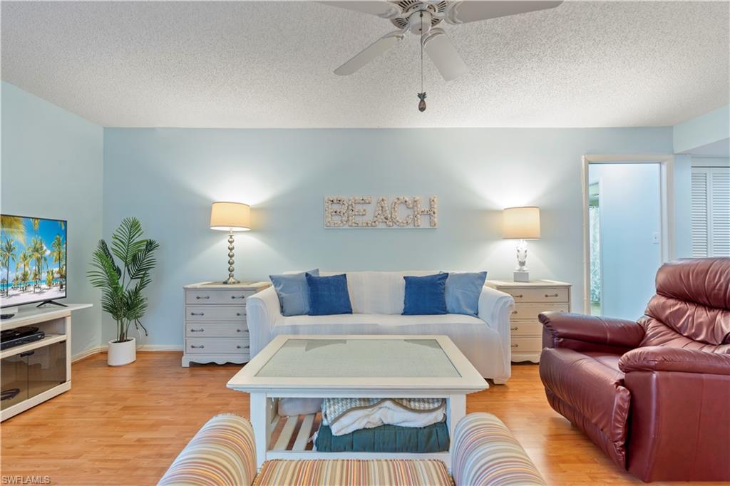 3200 Binnacle Drive, Unit C1 Naples, FL 34103 - Photo 4 of 37 a living room with furniture and a chandelier