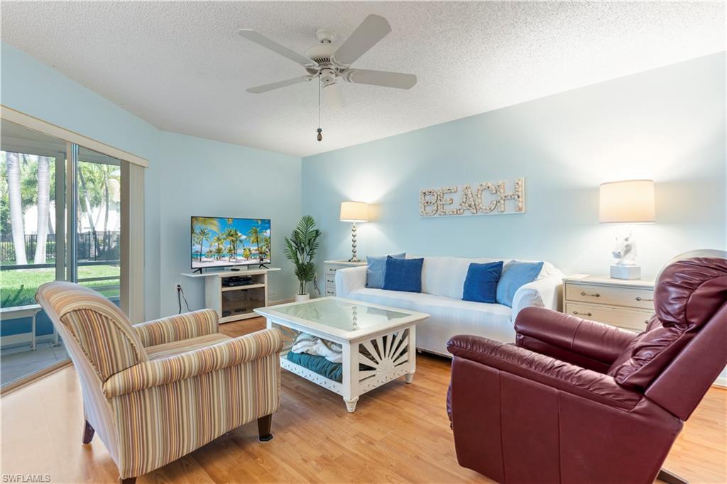 3200 Binnacle Drive, Unit C1 Naples, FL 34103 - Photo 5 of 37 a living room with furniture and a large window
