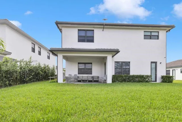 a view of a lake with table and chairs