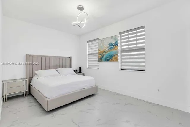 a spacious bedroom with a bed and a window