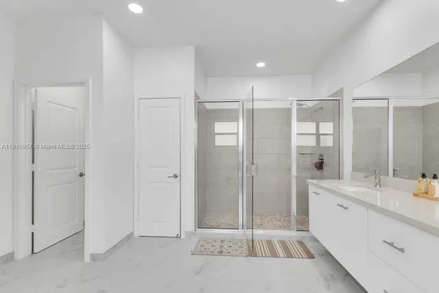 a bathroom with a sink mirror vanity and toilet