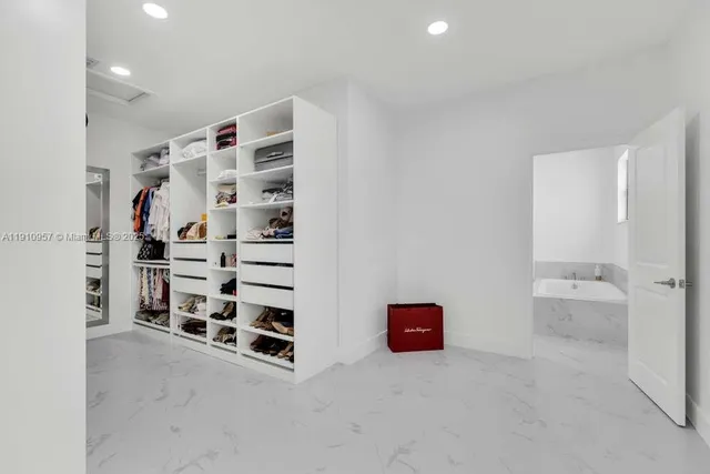 a view of kitchen with stainless steel appliances granite countertop a sink and a refrigerator