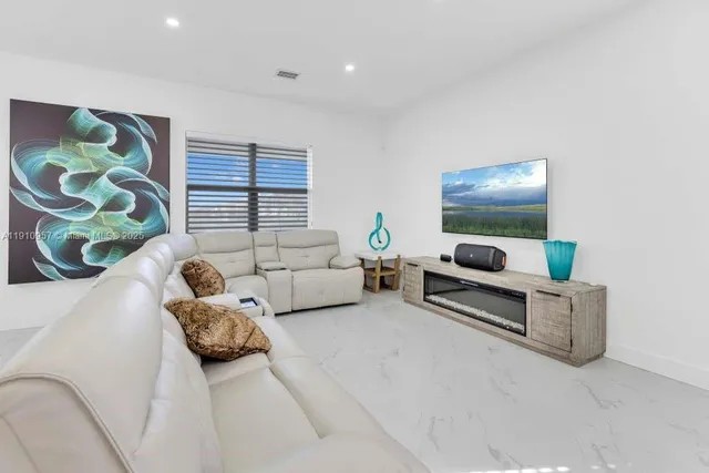 an aerial view of a house with a swimming pool