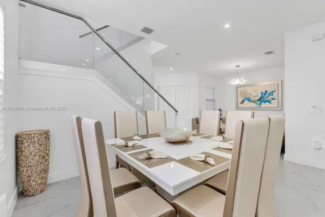 an aerial view of a house with a garden and lake view