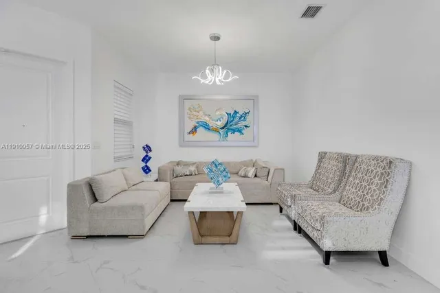 an aerial view of a house with a garden and lake view