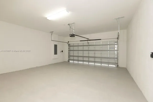 a living room with furniture and large windows