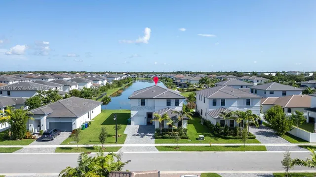 an aerial view of a house with a swimming pool outdoor seating and yard