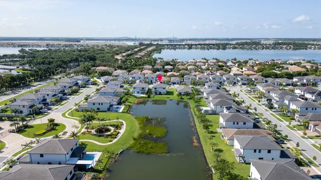 an aerial view of a house with a garden and lake view