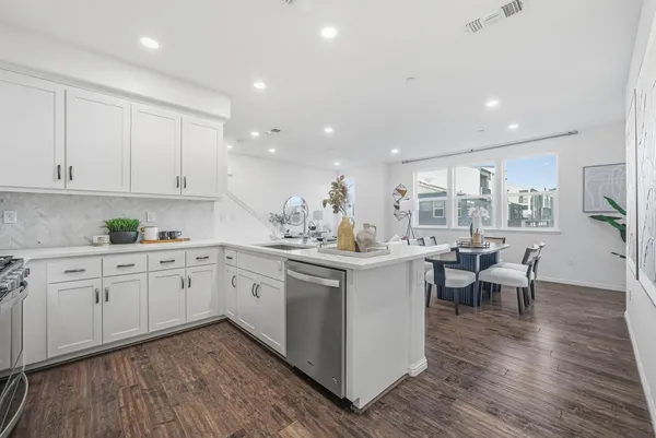 a kitchen with sink cabinets and wooden floor